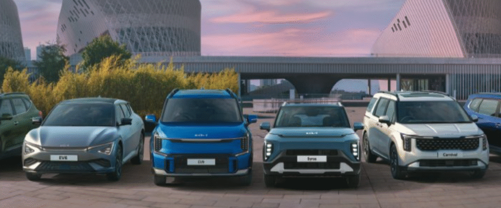 KIA vehicle lineup displayed at showroom including Seltos, EV6, Sonet, Syros, Carnival and Clavis models available at JSP KIA dealership in Bangalore